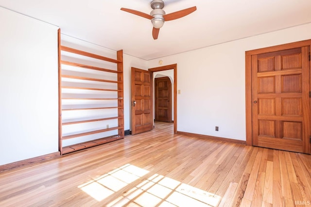 spare room featuring ceiling fan and light hardwood / wood-style floors