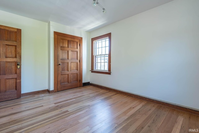 unfurnished room with light hardwood / wood-style floors