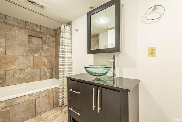 bathroom featuring vanity and shower / bath combo