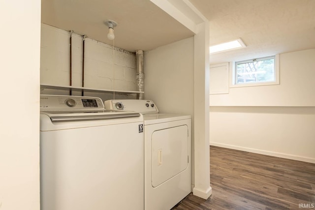 washroom with dark wood-type flooring and washer and dryer