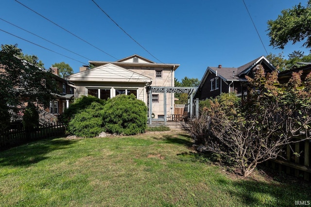 back of house with a lawn