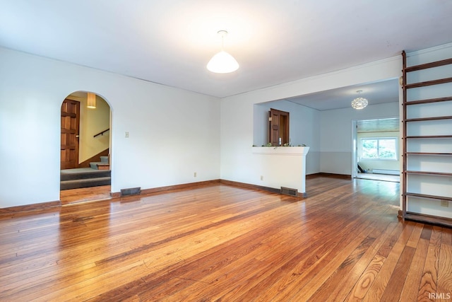 unfurnished living room featuring hardwood / wood-style flooring