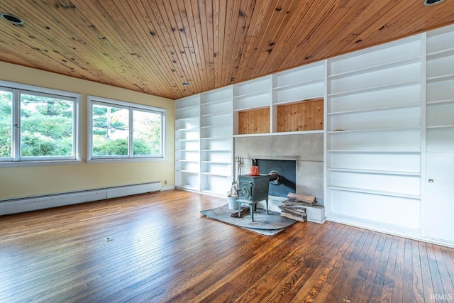 unfurnished living room featuring hardwood / wood-style flooring, built in features, a baseboard heating unit, wooden ceiling, and a wood stove