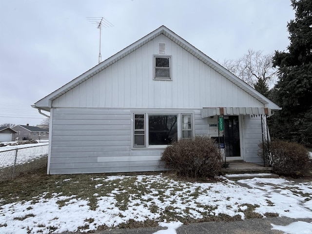 view of snow covered rear of property