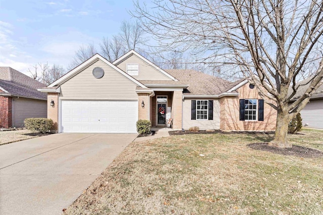 view of front of house featuring a garage and a front lawn