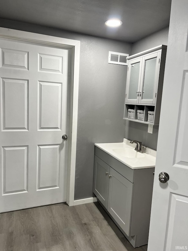 bathroom featuring vanity and wood-type flooring