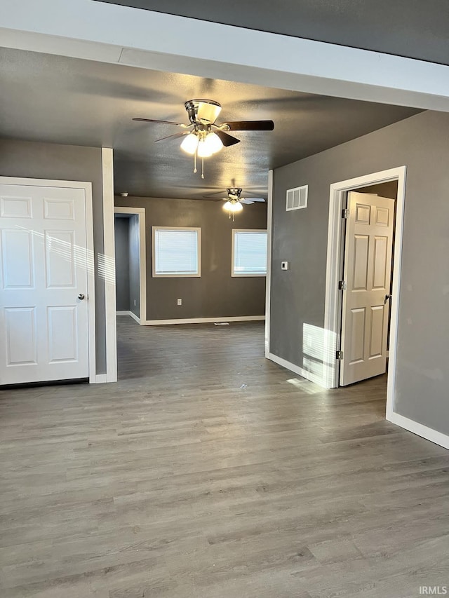 empty room featuring wood-type flooring and ceiling fan