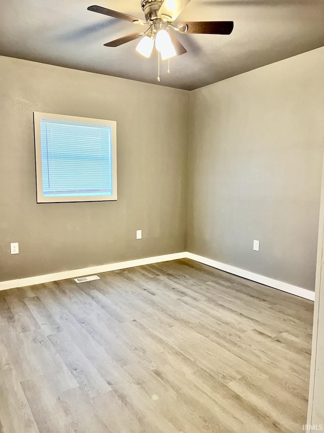 empty room with light hardwood / wood-style flooring and ceiling fan