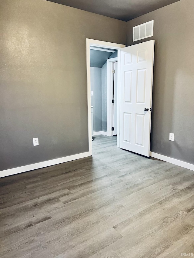 empty room with light hardwood / wood-style flooring