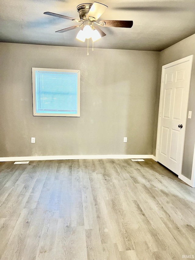 spare room featuring ceiling fan and light wood-type flooring