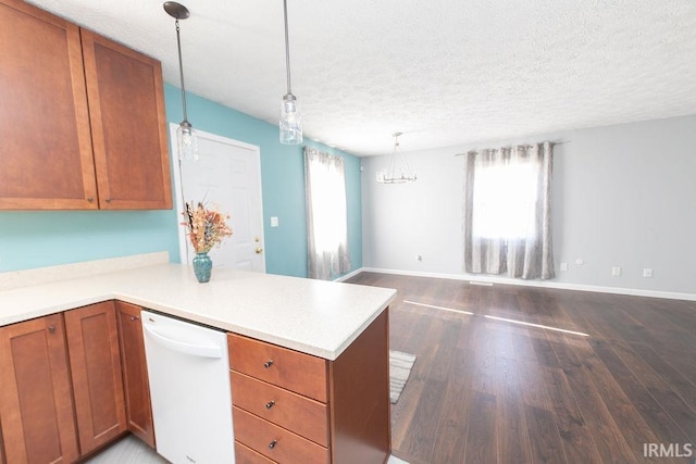 kitchen with decorative light fixtures, kitchen peninsula, dishwasher, and a textured ceiling