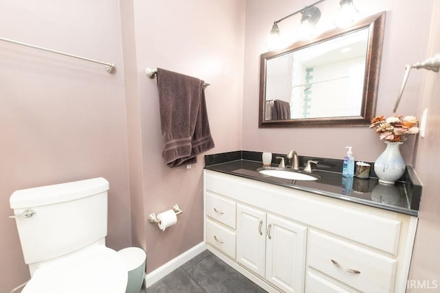 bathroom with vanity, toilet, and tile patterned flooring