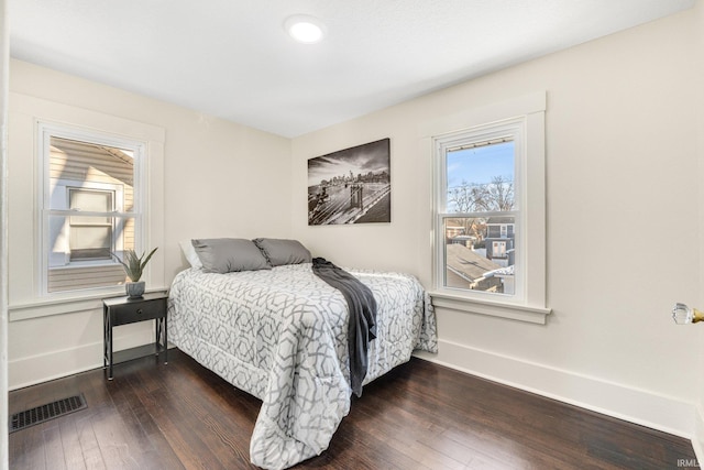 bedroom with dark wood-type flooring