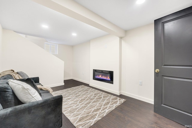 living room with dark wood-type flooring and beamed ceiling