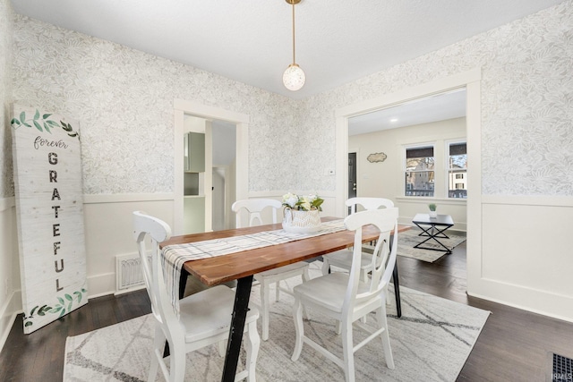 dining space with dark hardwood / wood-style floors