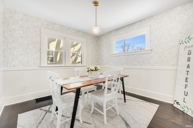 dining area featuring dark hardwood / wood-style floors