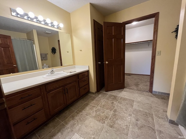 bathroom with vanity and a textured ceiling