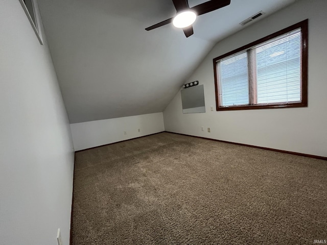 additional living space with ceiling fan, carpet flooring, and vaulted ceiling