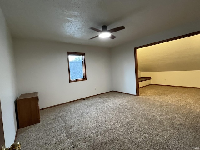 bonus room with carpet floors, a textured ceiling, and ceiling fan