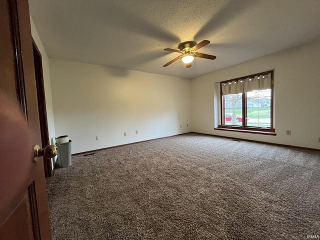 carpeted empty room featuring a textured ceiling and ceiling fan