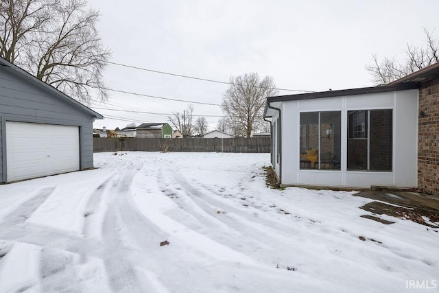 yard layered in snow with a garage