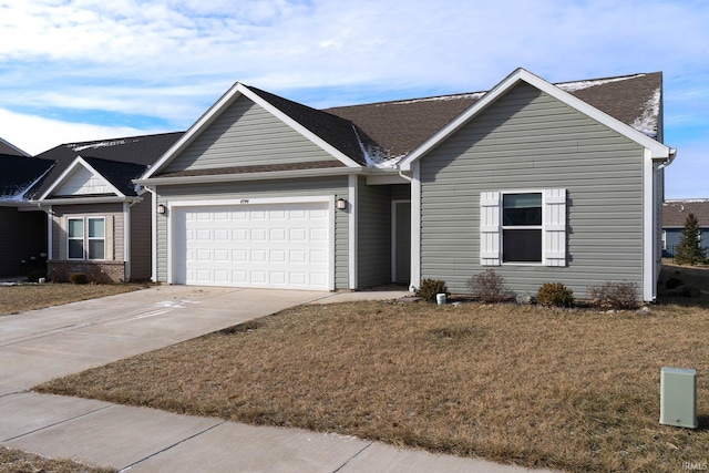 single story home featuring a garage and a front lawn