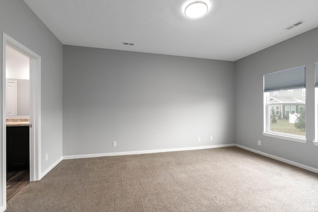 empty room featuring carpet flooring