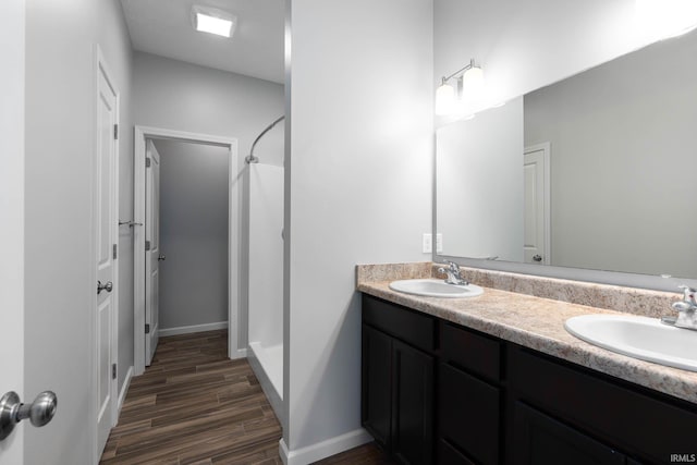 bathroom with walk in shower and vanity