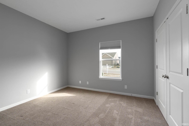 unfurnished bedroom with light colored carpet