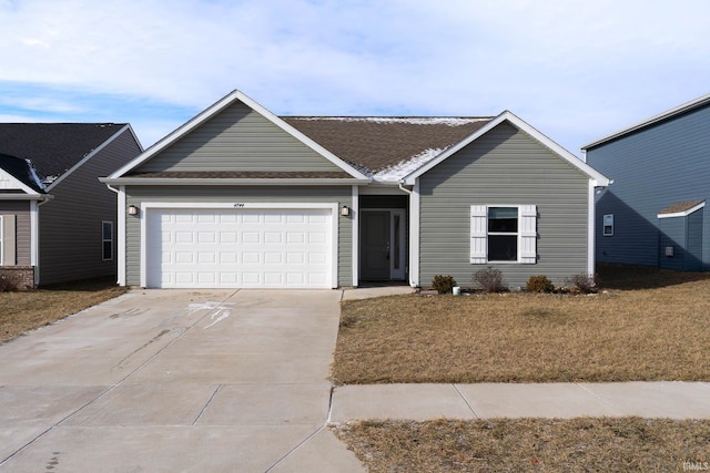 ranch-style home featuring a garage and a front yard