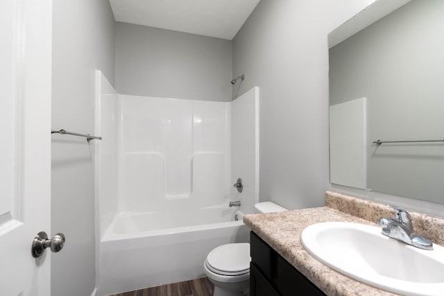 full bathroom with vanity, toilet, hardwood / wood-style floors, and shower / bathing tub combination