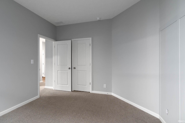 unfurnished bedroom featuring light colored carpet