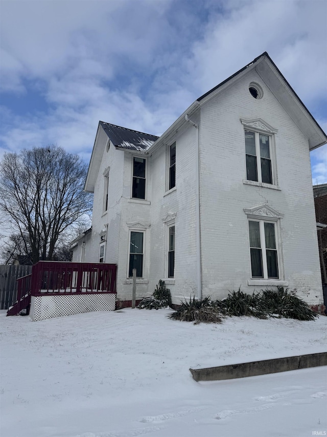 view of snowy exterior with a deck