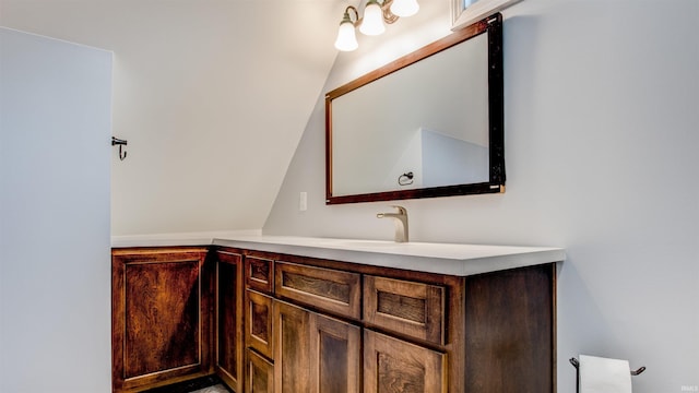 bathroom with vanity and vaulted ceiling