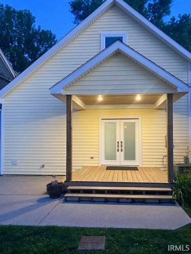 back of house with a patio, a deck, and french doors