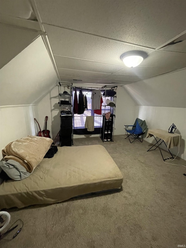 carpeted bedroom with lofted ceiling