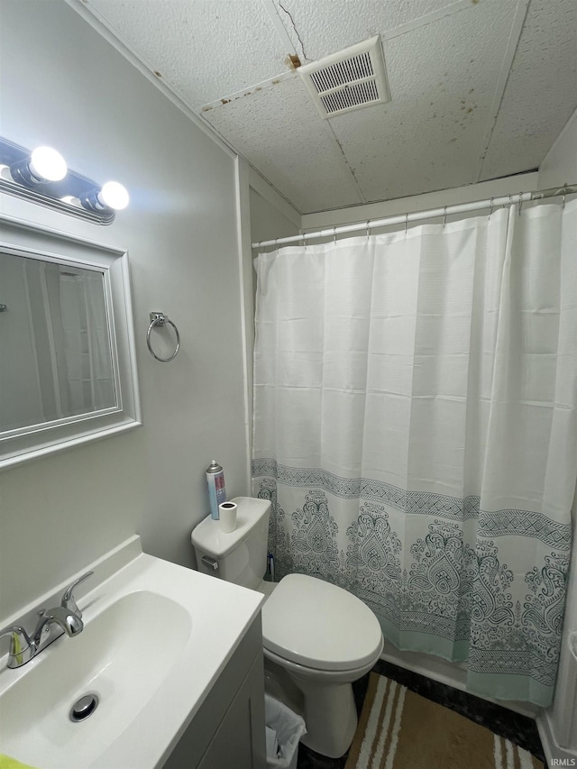 bathroom with vanity, toilet, and walk in shower