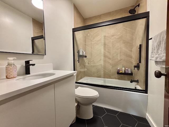 full bathroom featuring vanity, toilet, tile patterned flooring, and combined bath / shower with glass door