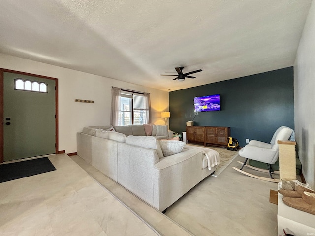 living room with a textured ceiling and ceiling fan