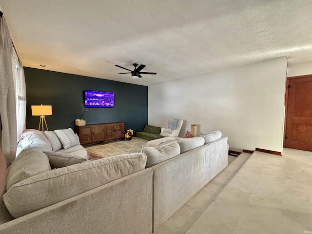 living room with ceiling fan and a textured ceiling