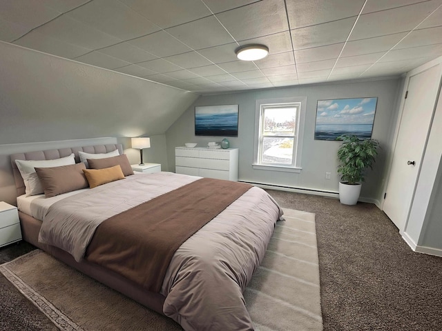 carpeted bedroom with lofted ceiling and a baseboard heating unit