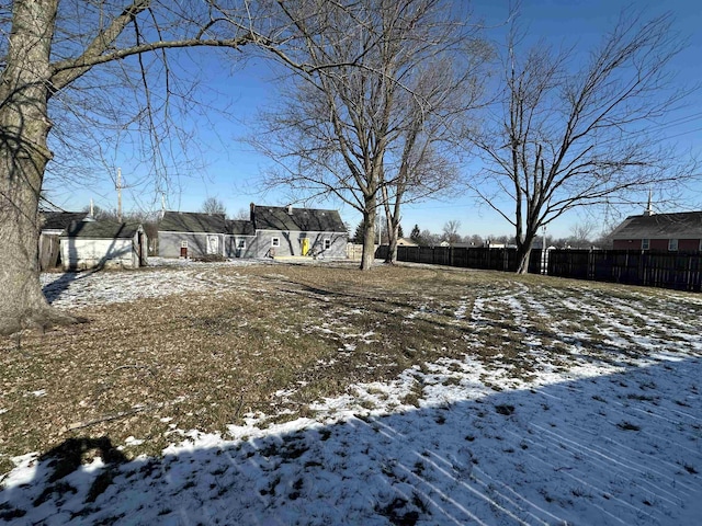 snowy yard with fence
