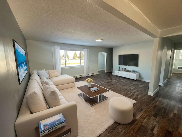 living room featuring dark hardwood / wood-style floors and a textured ceiling