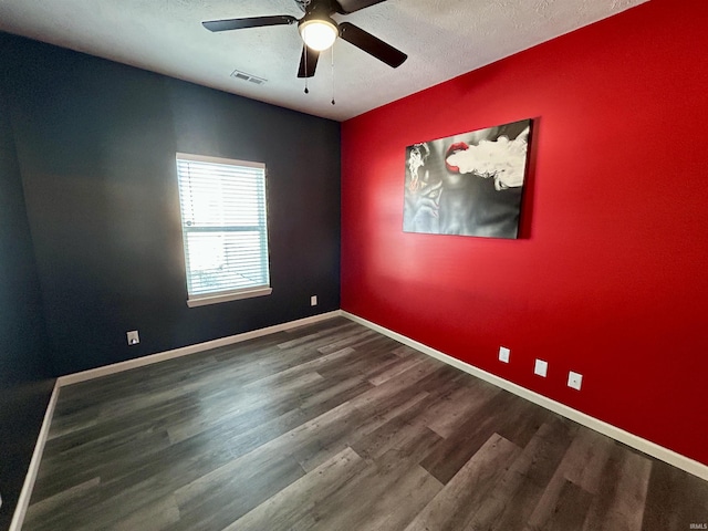 empty room featuring ceiling fan, hardwood / wood-style floors, and a textured ceiling