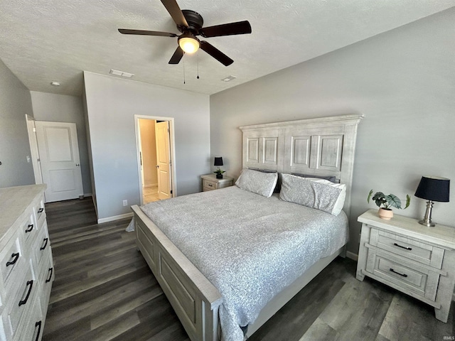 bedroom featuring ceiling fan, dark hardwood / wood-style flooring, ensuite bath, and a textured ceiling