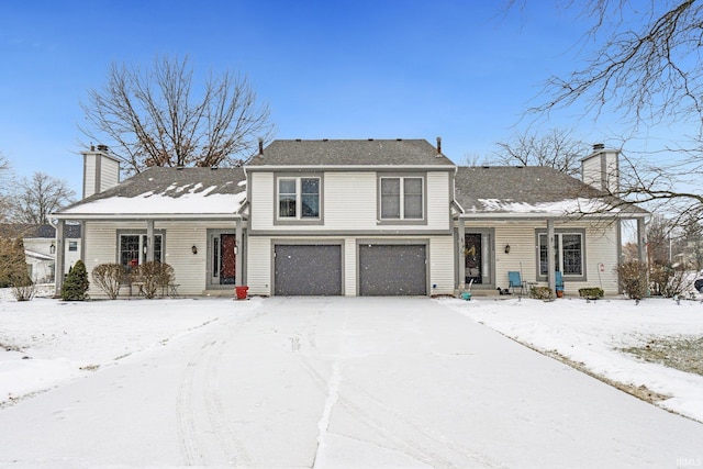 split level home featuring a garage and covered porch