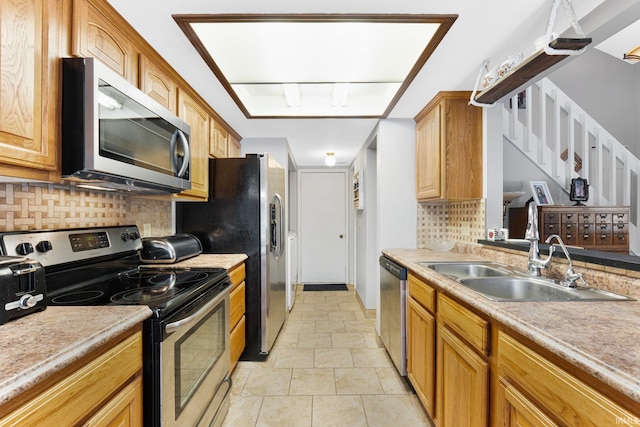 kitchen featuring tasteful backsplash, light tile patterned flooring, appliances with stainless steel finishes, and sink