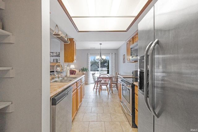 kitchen with sink, light tile patterned floors, an inviting chandelier, stainless steel appliances, and decorative light fixtures