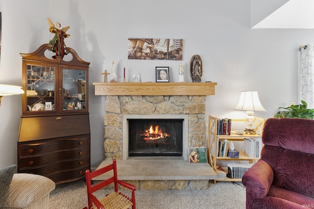 carpeted living room featuring a fireplace