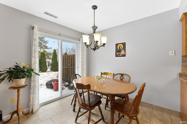 dining space featuring an inviting chandelier and light tile patterned floors